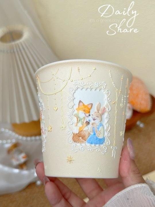 Handmade ceramic cup with hand-painted fox and rabbit illustration
