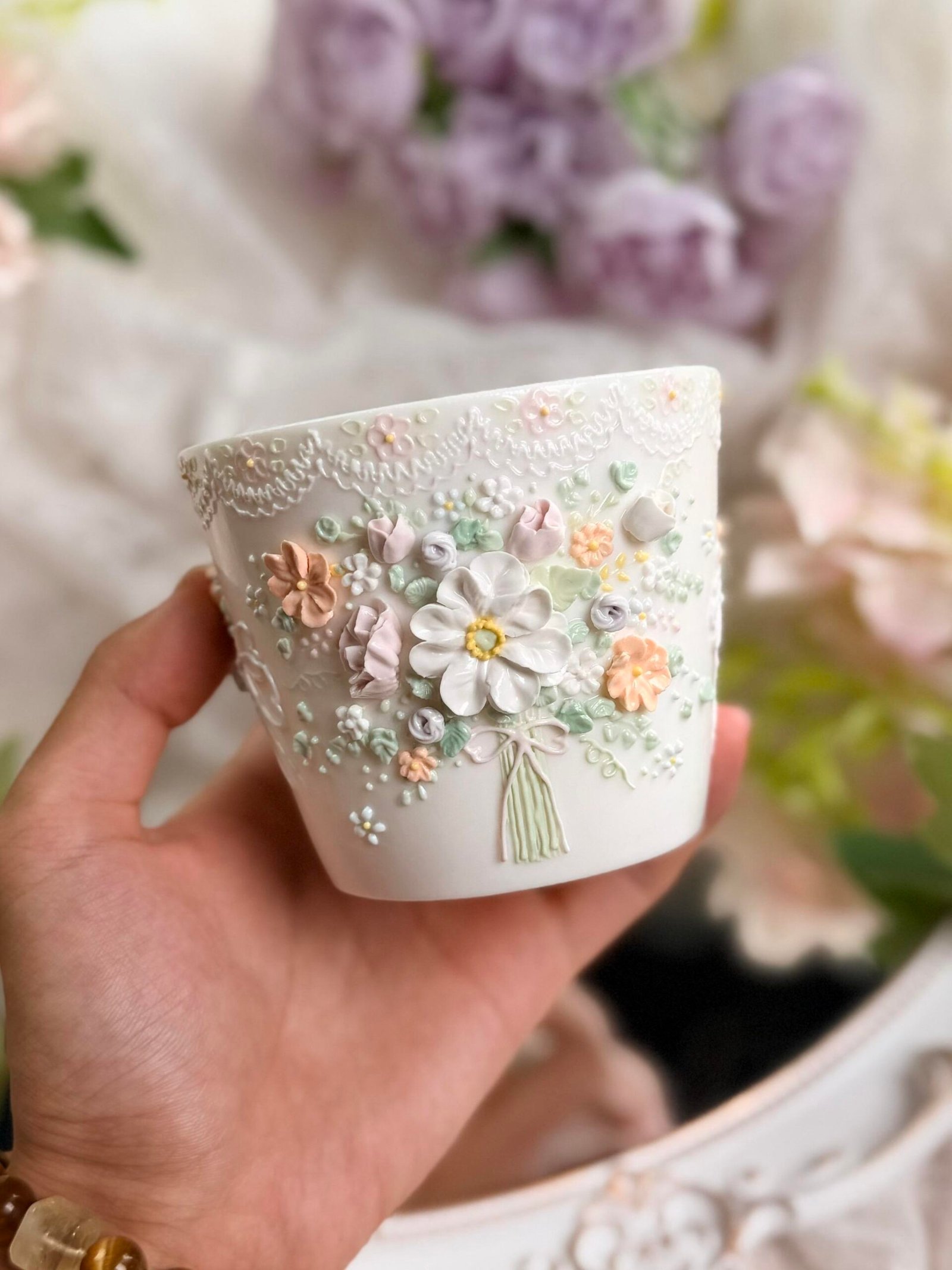White ceramic cup with raised pastel floral details