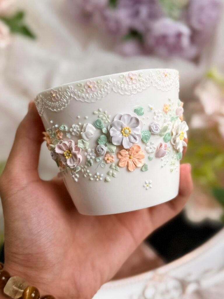 White ceramic cup with raised pastel floral details
