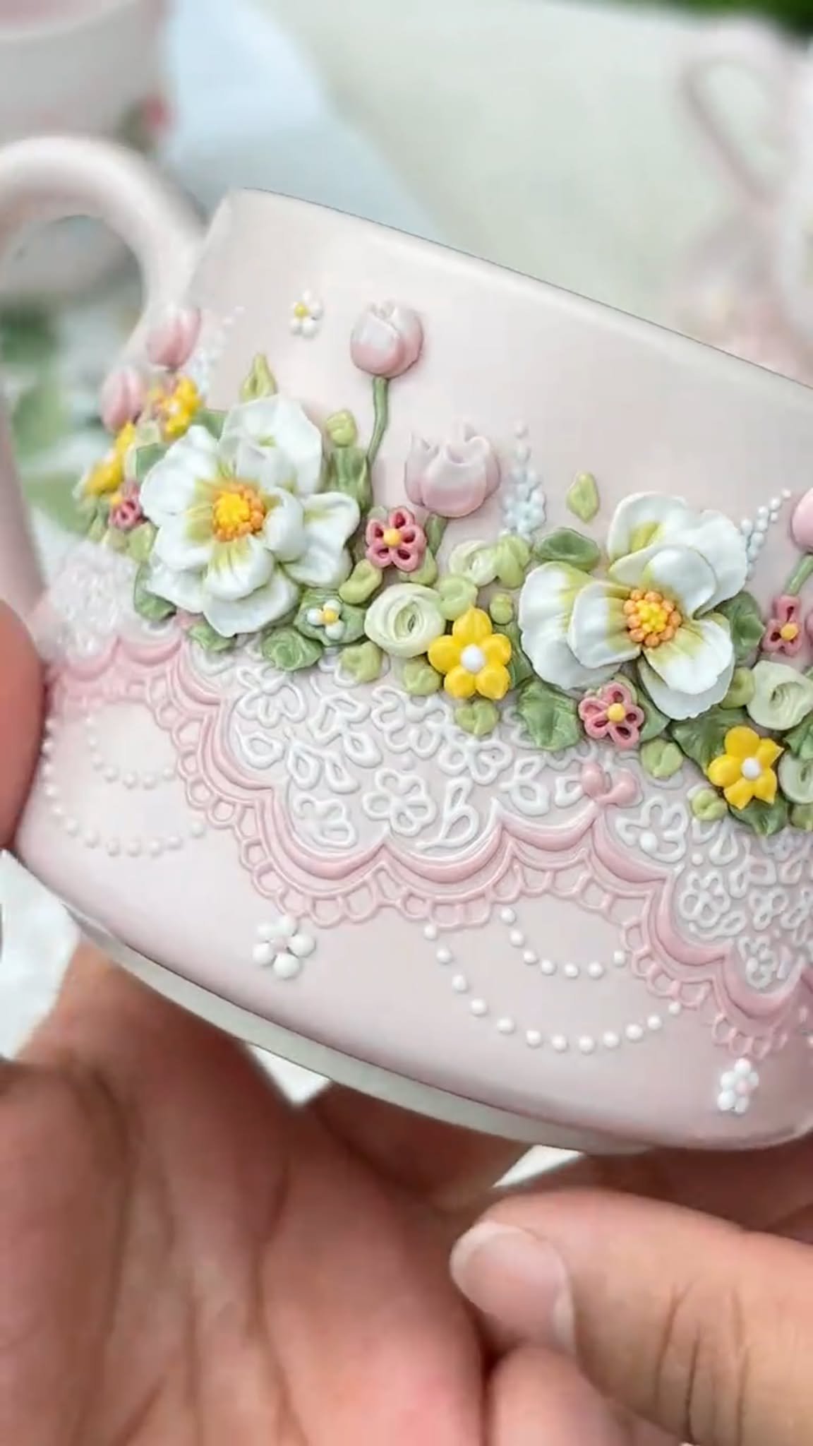 Pink floral ceramic mug with raised white flowers, pink buds and lace-inspired details